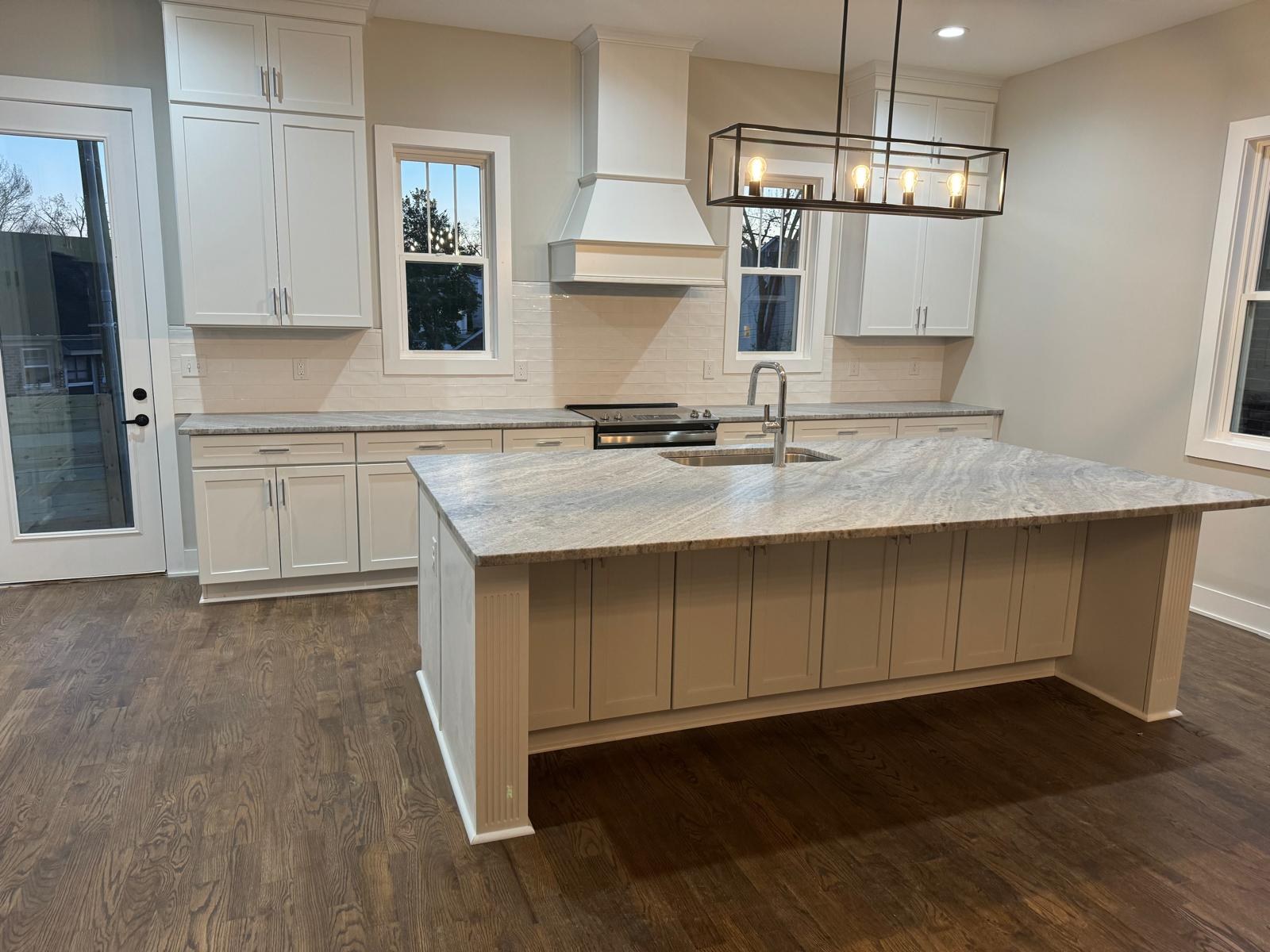 A bright, spotless kitchen with a large island after cleaning