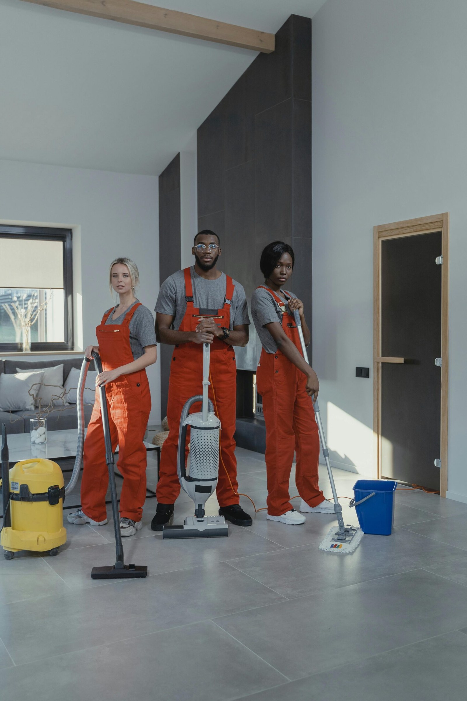 Three uniformed Victoria cleaning professionals standing in a home